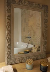 a bathroom with a bath tub in a mirror at Suite Parolin in Marostica