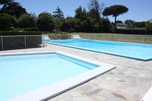 a large swimming pool in a yard at Appartement Vue Mer 180deg in Saint-Georges-de-Didonne