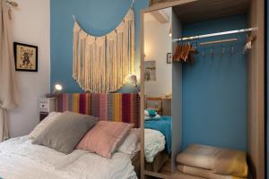 a bedroom with a mirror next to a bed at Guest House Blue Wave in Dubrovnik