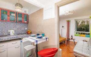 a kitchen with a red stool in a room at The Art Republic, Old Town in Dubrovnik