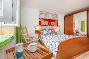 a bedroom with a bed with a wooden head board at The Art Republic, Old Town in Dubrovnik