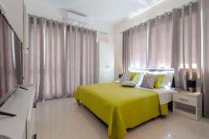 a bedroom with a bed with a yellow blanket at Studio Apartment & Room TEN - Free parking in Dubrovnik