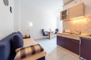 a living room with a couch and a kitchen at Apartments Radulj in Goveđari +28 photos