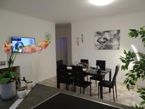 a dining room with a black table and chairs at Lifestyle Balaton in Siófok