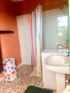 a bathroom with a shower curtain and a sink at Finca Arcoíris Tenerife VV in Guía de Isora