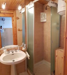 a bathroom with a sink and a shower at La casa di Pila in Pila