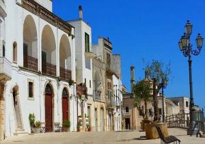 a city street with white buildings and a bench at Casa Magnolia in Montalbano
