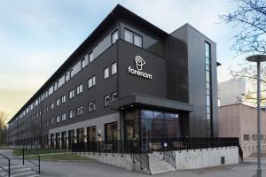 a black building with the fotoren logo on it at Forenom Hotel Kista in Stockholm