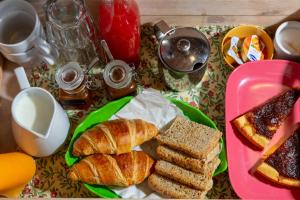 a table topped with a plate of bread and pastries at B&B Sotto le Stelle in Fano +35 photos