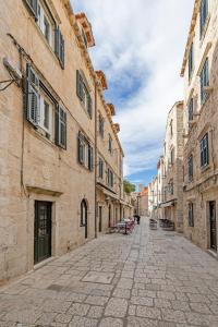 an empty street in an old town with buildings at The Art Republic 2, Old Town in Dubrovnik