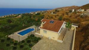an overhead view of a house with a swimming pool at Happy Trails Pomos Panoramic Villa in Pomos