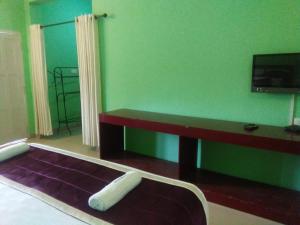 A television and/or entertainment centre at Konark Homestay