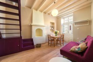 a living room with a purple couch and a table at Colourful Home, Medieval Town Rhodes in Rhodes Town