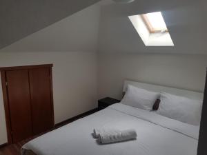 a bedroom with a large white bed with a skylight at PROKLETIJE HOTELL Same in Brezojevica +157 photos