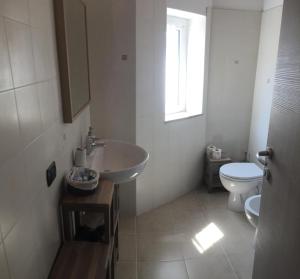 a bathroom with a sink and a toilet at Ca' di Bianca in Moneglia