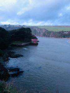 a house in the middle of a large body of water at The Downs, Thurlestone, South Devon, close to several beaches in Kingsbridge