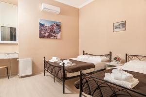 a hotel room with two beds and a kitchen at HOME 6 in Tbilisi City