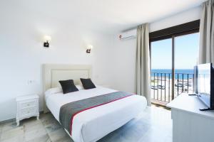 Säng eller sängar i ett rum på Hotel El Ancla