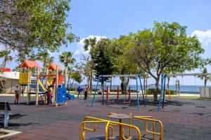 a park with a playground with people and the ocean at Limassol Old Town Mansion - Steps to the Sea , Marina and Center in Limassol