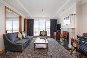a living room with a couch and a tv at Leonardo Royal Southampton Grand Harbour in Southampton