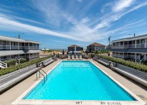 a large swimming pool in front of some buildings at Saltaire Cottages in Kitty Hawk Beach