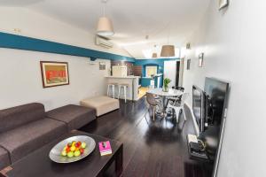 a living room with a couch and a table at Rory Apartments in Zadar