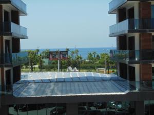 a view of the pool from the balcony of a building at Бежевые апартаменты in Batumi