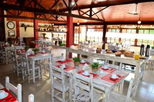 a restaurant with tables and chairs in a room at Pousada Vale Do Ermitão in Penedo