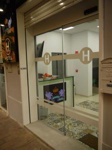 a glass door of a store with the h signs on it at Hotel Maravillas del Mundo in Calpe