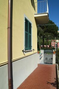 a balcony with a window and a brick floor at La Casa Delle Rose in La Spezia