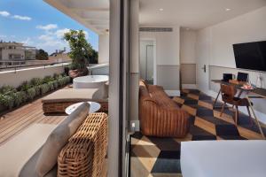 a balcony with a view of a living room at Sam&Blondi in Tel Aviv