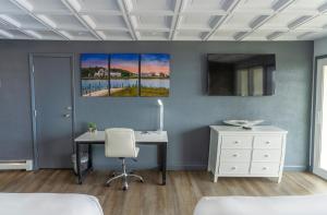 a bedroom with a desk and a computer on a wall at Terrace Bay Hotel - Lakefront in Escanaba