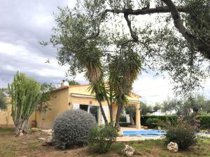 a villa with a pool and a house at La Inopia in L'Ampolla