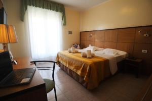 Postel nebo postele na pokoji v ubytování Hotel Righetto Fronte Mare