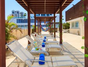 a row of chaise lounges on a patio at GIO hotel Tama Cartagena in Cartagena de Indias