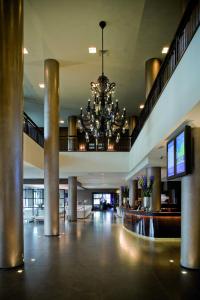 un gran vestíbulo con una lámpara de araña en un edificio en Van der Valk Hotel Houten Utrecht, en Houten