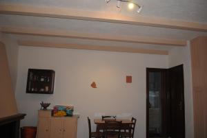 a dining room with a table and chairs and a ceiling at Essenza in Pitigliano