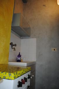 a kitchen with a sink and a stove top oven at Essenza in Pitigliano