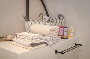 a pile of towels on a shelf in a bathroom at Panthemis in Leonidio