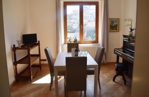 a dining room with a table and a piano at La Finestra su Siena in Siena
