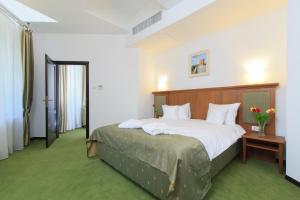 Postel nebo postele na pokoji v ubytování Hotel Palace