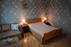 a bedroom with a bed and a couch at Family Hotel Mountain Scream in Tbilisi City +82 photos