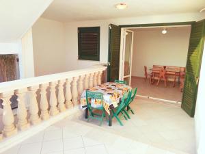 a balcony with a table and a dining room at Casa vacanza Tanja Leuca in Leuca