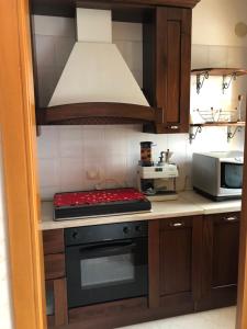 a kitchen with a stove and a microwave at Alberobello Relax in Alberobello