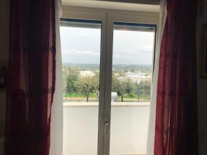 a sliding glass door with a view of a city at Alberobello Relax in Alberobello