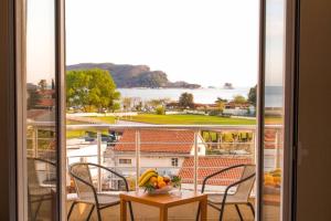 a view of a balcony with a table and chairs at Residence Bella in Budva