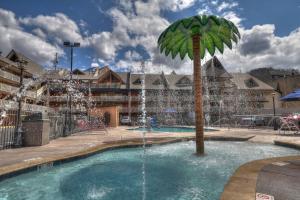una palmera en una piscina con una fuente en Crossroads Inn & Suites, en Gatlinburg