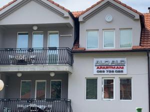 a house with aaniaarma sign on the side of it at Apartmani Alo Alo (kod Mikija) in Plav