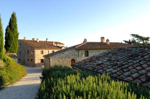 a group of buildings with plants in front of them at Relais Borgo Torale in Passignano sul Trasimeno +43 photos
