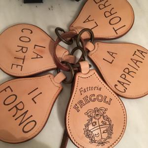 four brown leather tags with the words ragnarok on them at Agriturismo Il Macchione in Pienza